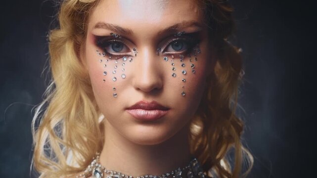 fantasy goddess portrait beauty strong face fashion model posing blonde hair dangerous young woman graphic professional make up shiny. teenager elf girl looking at camera closeup blue eyes art make-up