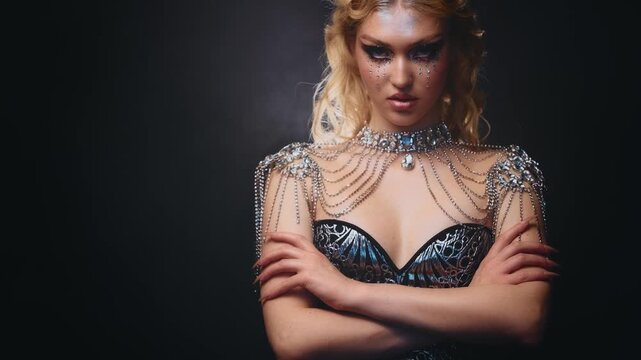 fantasy goddess portrait beauty strong face fashion model posing blonde hair dangerous young woman graphic professional make up shiny. teenager elf girl looking at camera closeup blue eyes art make-up
