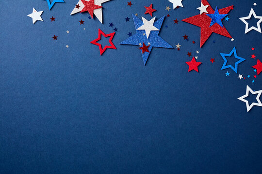 Top border composed of sparkling red, white, and blue stars on a dark blue background. Patriotic American holiday concept with empty copy space below for text or design.