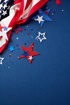 Vertical patriotic background with the US flag and scattered stars in the top left corner. Navy blue texture with empty space for Independence Day or Veterans Day text.