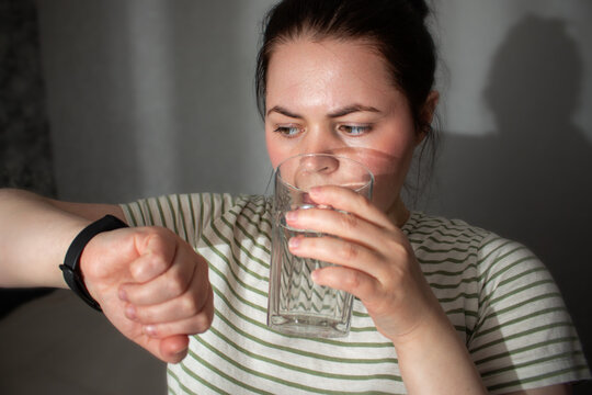 Woman checks health indicators using tracking app on smartwatch. Smart health means using devices as assistants not overlords. Low alarm high-awareness living. Digital detox concept