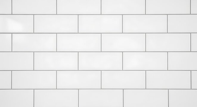 Clean glossy white subway tiles with grey grout lines arranged in a classic brick pattern for interior wall design