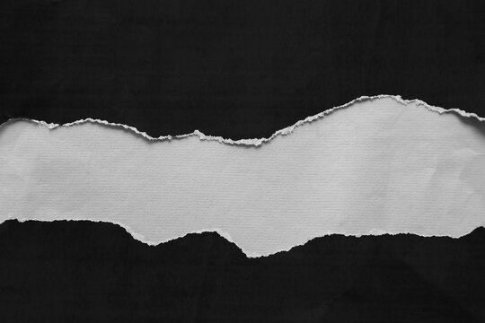 Ripped black paper on grey