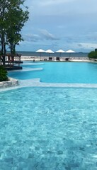 Obraz premium Peaceful Tropical Beachfront Landscape with Resort and Sea Horizon.