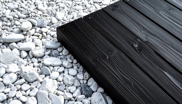 Contrasting textures of smooth pebbles and dark wood planks