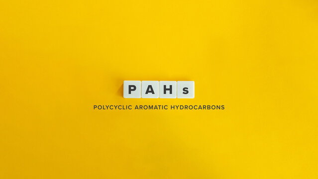 PAHs Polycyclic Aromatic Hydrocarbons Acronym on White Tiles Against Bright Yellow Background