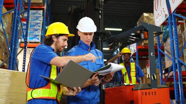 Factory manager and quality control inspector review production process line in food manufacturing plant with safety and industrial packaging operation in modern processing facility.