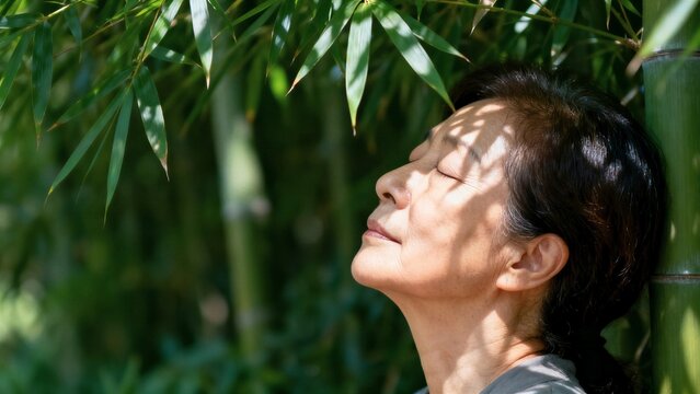 Dappled canopy shelter and natural cooling concept with mature Japanese woman resting in profile heatwave portrait.