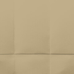 Fototapeta premium Beige folded paper texture with subtle creases and shadows.