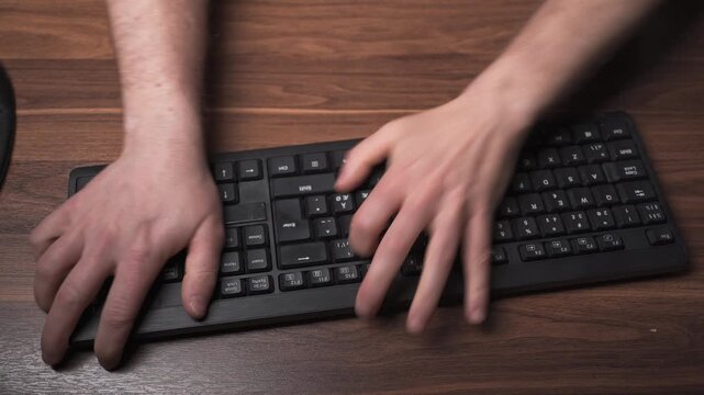 Frustrated hitting keyboard and throwing it off desk in home office