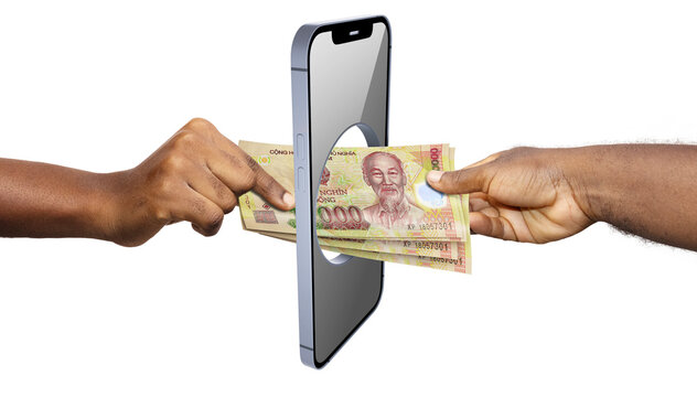 A conceptual image shows a stack of Vietnamese Dong banknotes being passed directly through a hole in a smartphone screen between two hands, symbolizing digital transactions and online banking.