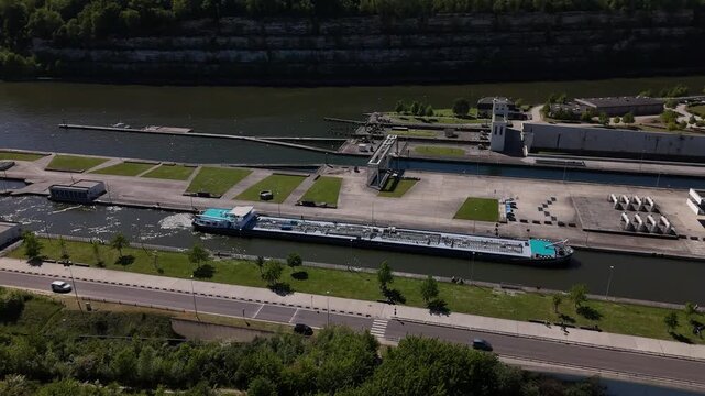 Exploring the river lock at Ecluse de Lanaye on the Maas River between Belgium and the Netherlands with a barge entering the lock