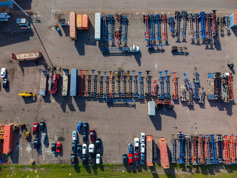 Aerial view of rows of colorful shipping container trailers and parked vehicles in a logistics yard at Arawak Cay in Nassau, New Providence, The Bahamas.