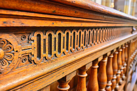 Close up of ornate antique wood carvings and balusters on a historic church balustrade