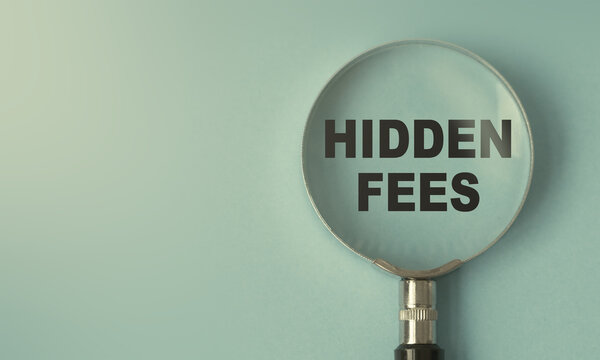 hidden fees text under magnifying glass representing business fees taxes concept and hidden costs revealed symbol design