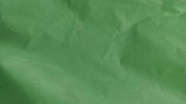 Green abstract background texture of bioplastic or biodegradable plastic like nature and eco friendly alternative carry bag surface made with starch based polymer material. Stop motion animation loop.