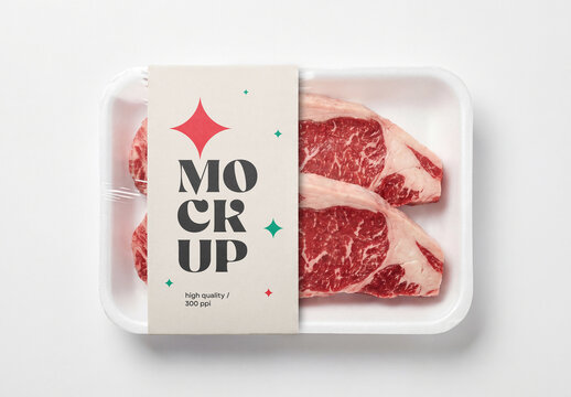 Top view of raw beef steak meat food packaging tray mockup with plastic wrap film and a vertical paper sleeve isolated on a white background