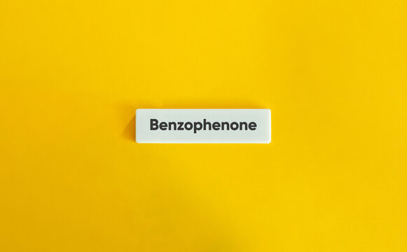 Benzophenone Chemical Ingredient Text on a White Block Against a Bright Yellow Background