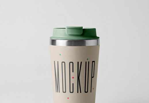 Close-up front view of a reusable thermal travel coffee mug mockup with a green plastic lid isolated on a solid grey background