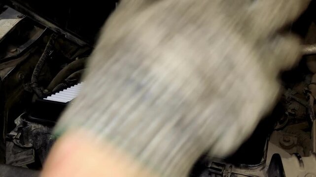 A close-up shot of replacing an engine air filter