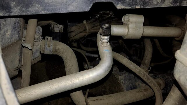 A close-up shot of car air conditioner lines and valves