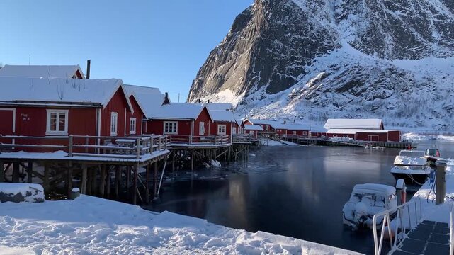 Snow-Covered Red Fishing Cabins by Fjord and Mountain