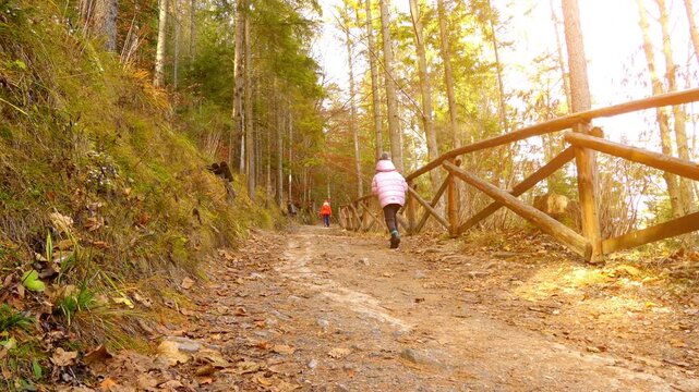 Two little beautiful girls walk near Belianska Cave, is stalactite cave in Slovak part of mountains, largest and only one open to public in Tatras. Vysoke Tatry, Tatranska Kotlina, Lendak, Slovakia.