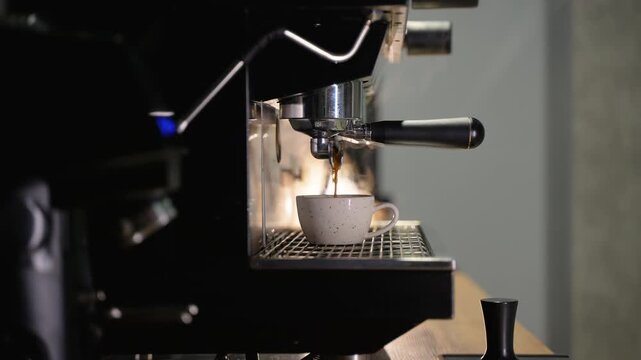 Barista preparing fresh hot espresso coffee drink