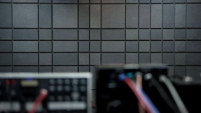 Detailed medium shot showcasing flat acoustic foam panels mounted on a music room wall providing uniform sound absorption and minimizing background noise for clear audio sessions