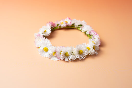 Midsummer wreath of wild flowers on pastel background