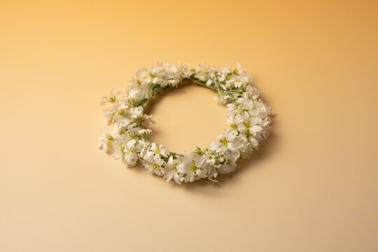 Midsummer wreath of wild flowers on pastel background