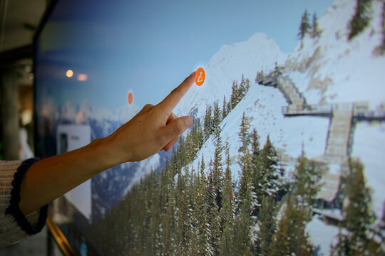 Hand touching interactive map screen close up