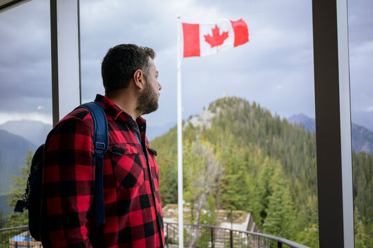 Man looking at Canada flag from indoor viewpoint