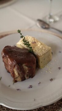 Pork Bondiola with Potato Millefeuille in a gala table setting
