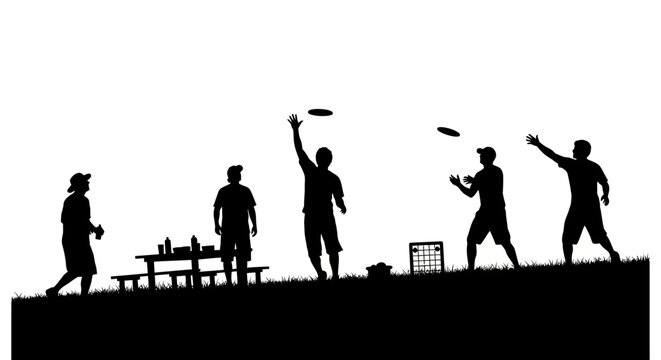 People play frisbee on a hill with picnic tables and benches nearby.