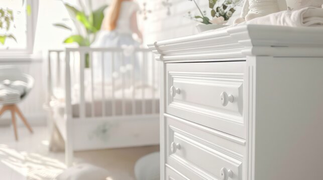 White dresser with intricate details and oval knobs
