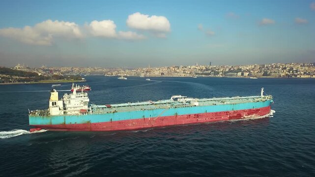 Suezmax Crude oil tanker ship navigating Bosphorus Strait near Golden Horn mouth with Galata Tower and Istanbul old city cityscape background