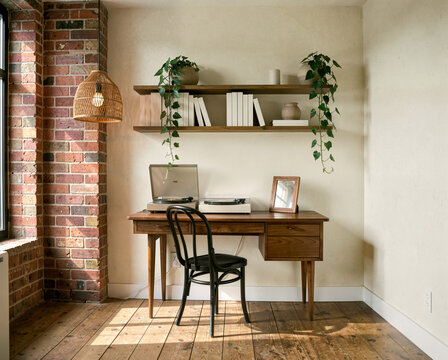 Wooden desk with vinyl record player in cozy home office by brick wall window