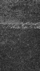 Fototapeta premium Dark, textured concrete mobile wallpaper with a rough, gritty surface and subtle white line