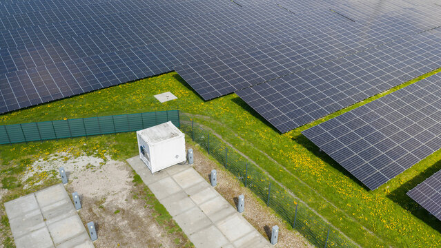 Aerial drone view of renewable battery storage at a solar park, balancing the grid and preventing net congestion in The Netherlands.