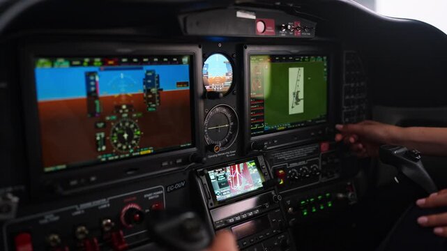 Pilot operating avionics control panel inside cockpit