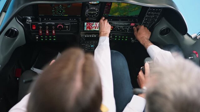 Professional pilot and copilot operating a modern aircraft cockpit