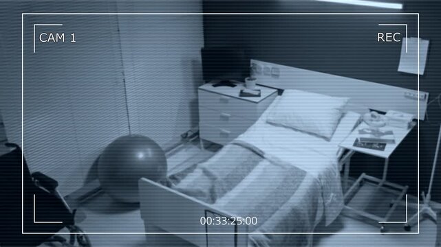 CCTV camera monitoring empty maternity ward hospital room with bed and fitness ball. Footage is perfect for medical security system promos or healthcare documentaries