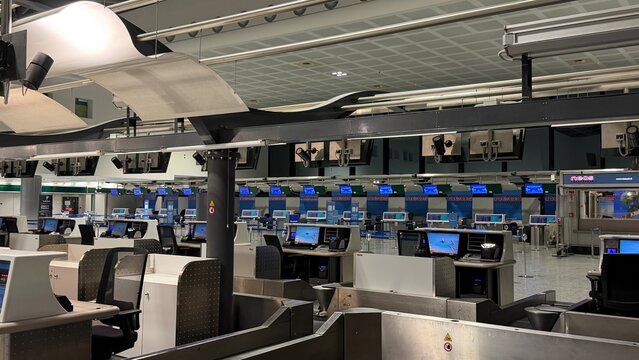 Empty Airport Registration Counters in Italy at Night