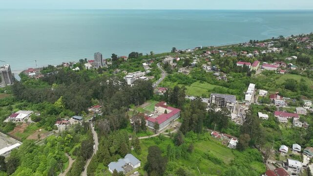 Chakvi, Georgia &mdash; May 22 2026: Aerial drone view of Public School N1 building complex surrounded by lush green trees and coastal landscape in Adjara region.