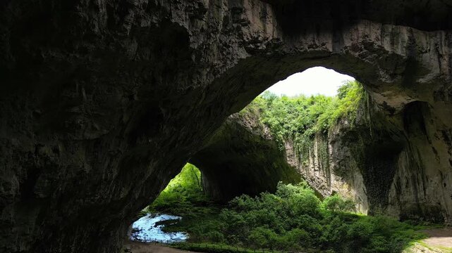 Sideways Drone Movement Inside Devetashka Cave with Natural Skylights