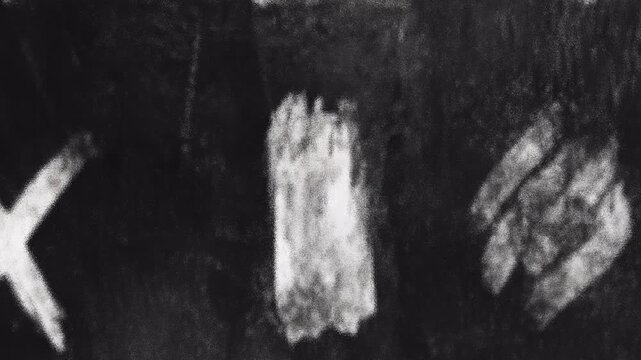 Handwritten White Chalk Marks on a Dark Textured Blackboard Surface.