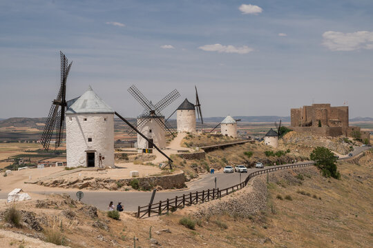 Traditional windmills and the medieval Castle of La Muela in Consuegra, Spain. Historic landmark of La Mancha associated with the story of Don Quixote.