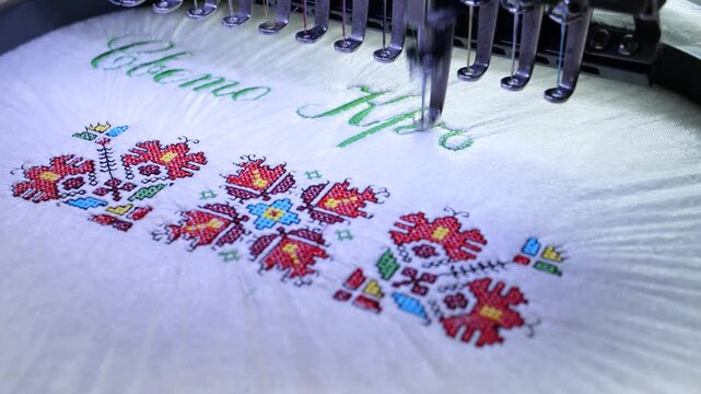 Machine embroidery of the inscription Holy Baptism with colored threads on a white terry cloth. Baptism cloth with cross stitch for Bulgarian tradition. 4k video.