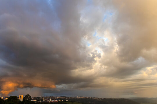 Dramatic Storm Clouds Forming Over City Skyline Indicating Severe Weather and Atmospheric Instability. 